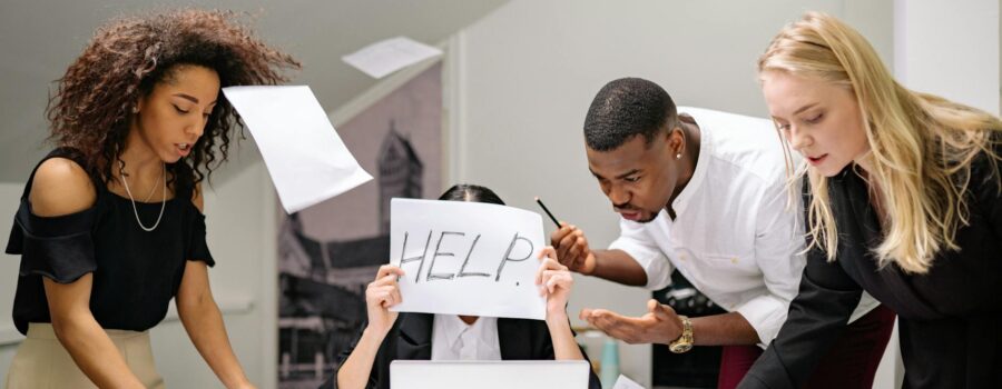people talking to a stressed coworker in the workplace