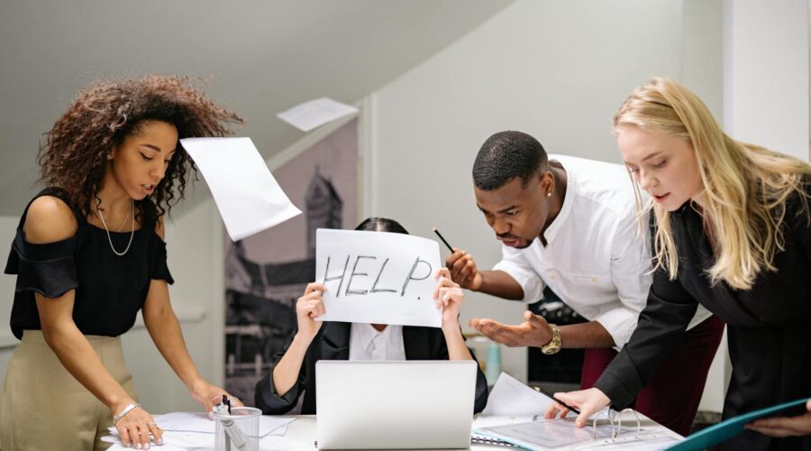 people talking to a stressed coworker in the workplace