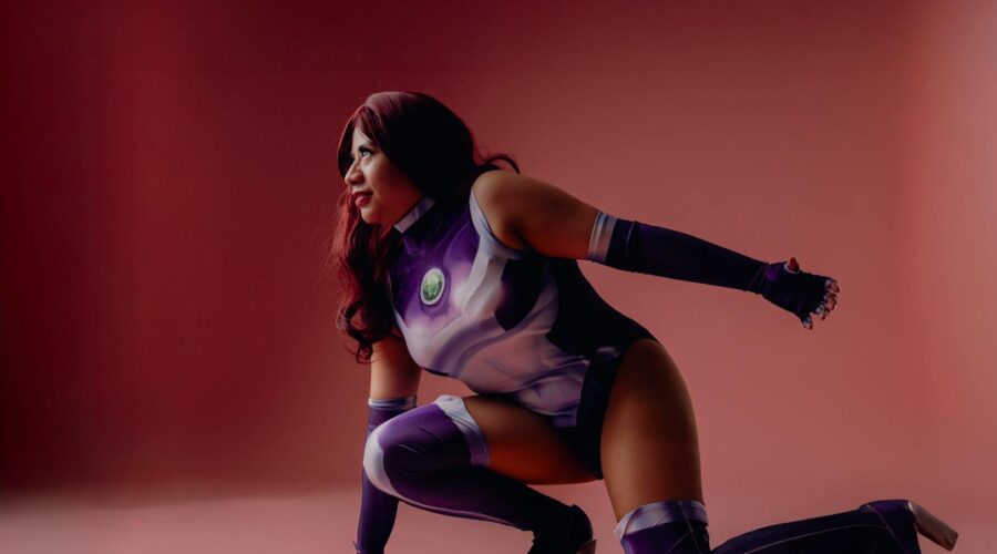 dynamic cosplay portrait on pink backdrop